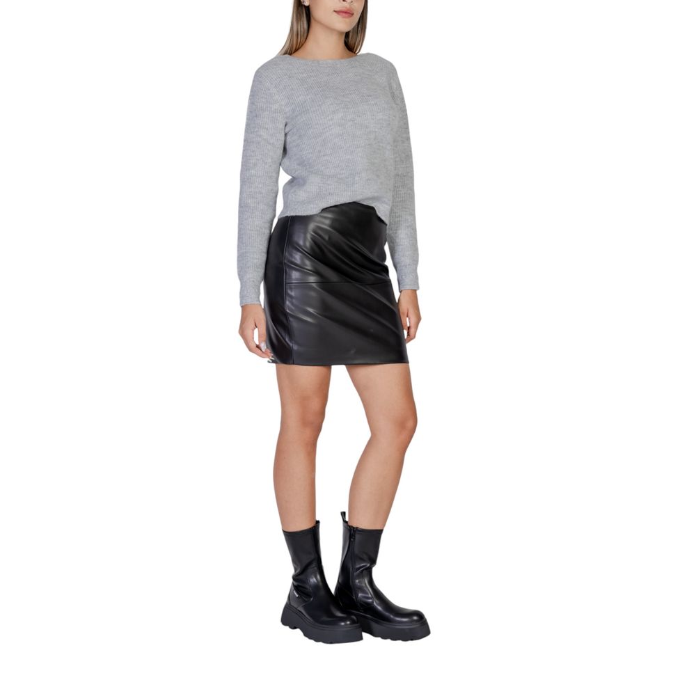 Woman wearing ICHI Black Polyethylene Mini Skirt with grey top and black boots, showcasing modern style and slim fit.