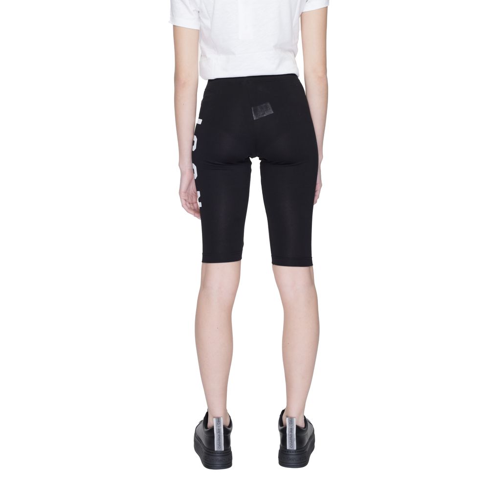 Back view of Icon Black Cotton Bermuda Shorts with bold 'ICON' text on the side, featuring a comfortable and flexible fit for women.