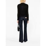 Back view of model wearing Iro Jackets Black with fringe detailing and round neck.