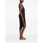Side view of model wearing JACQUEMUS Dresses Black La Robe Peplo Courte, crew neck, sleeveless, asymmetric hem.