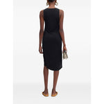 Back view of model wearing JACQUEMUS Dresses Black, sleeveless asymmetric hem dress, holding small purse.