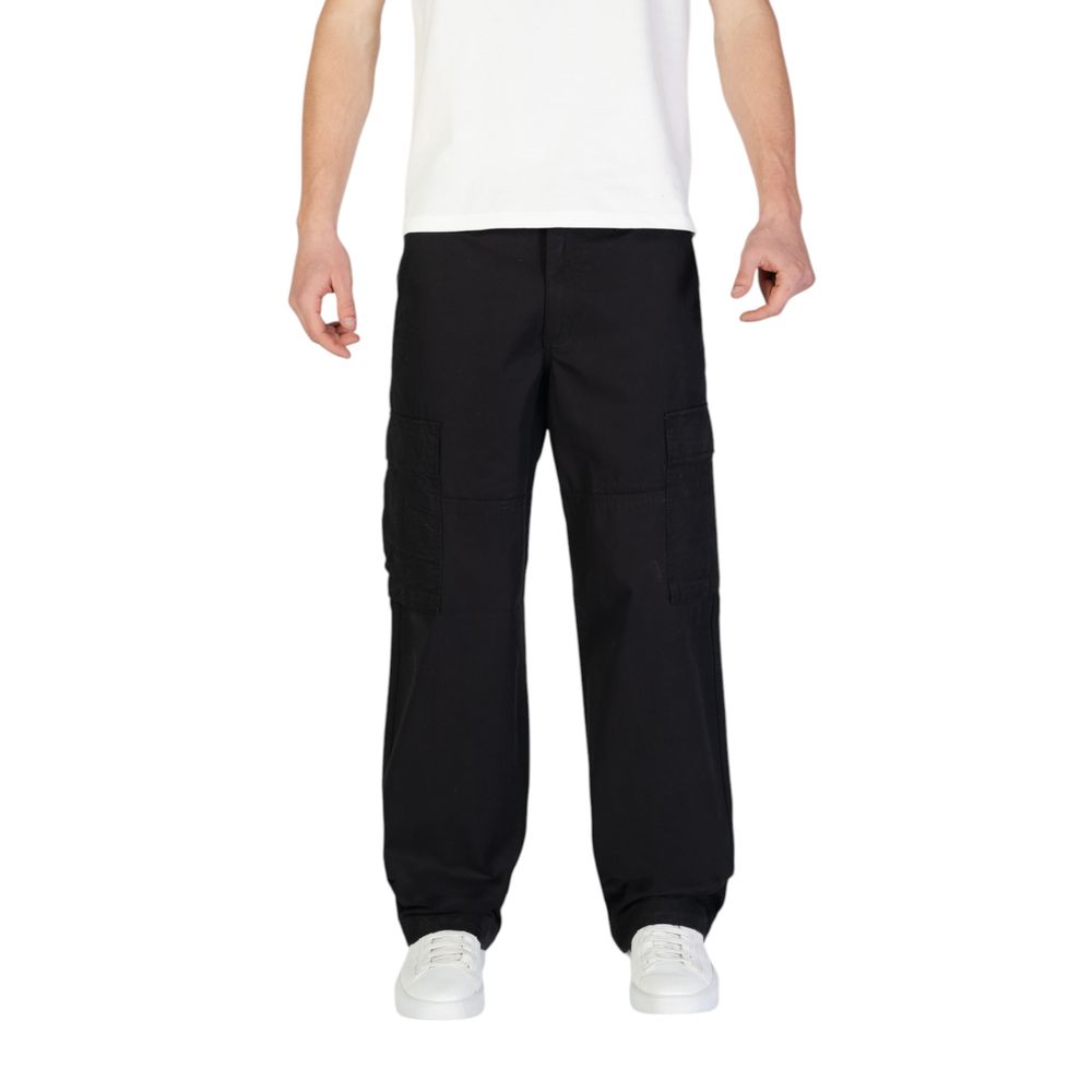 Man wearing Jack Jones Black Cotton Cargo Pants with side flap pockets, showcasing comfort and style.