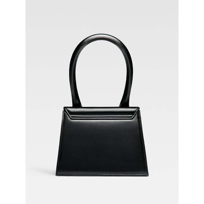 Jacquemus Le Chiquito Moyen Black Bag with gold hardware, reinforced handle, removable shoulder strap, and magnetic flap closure.
