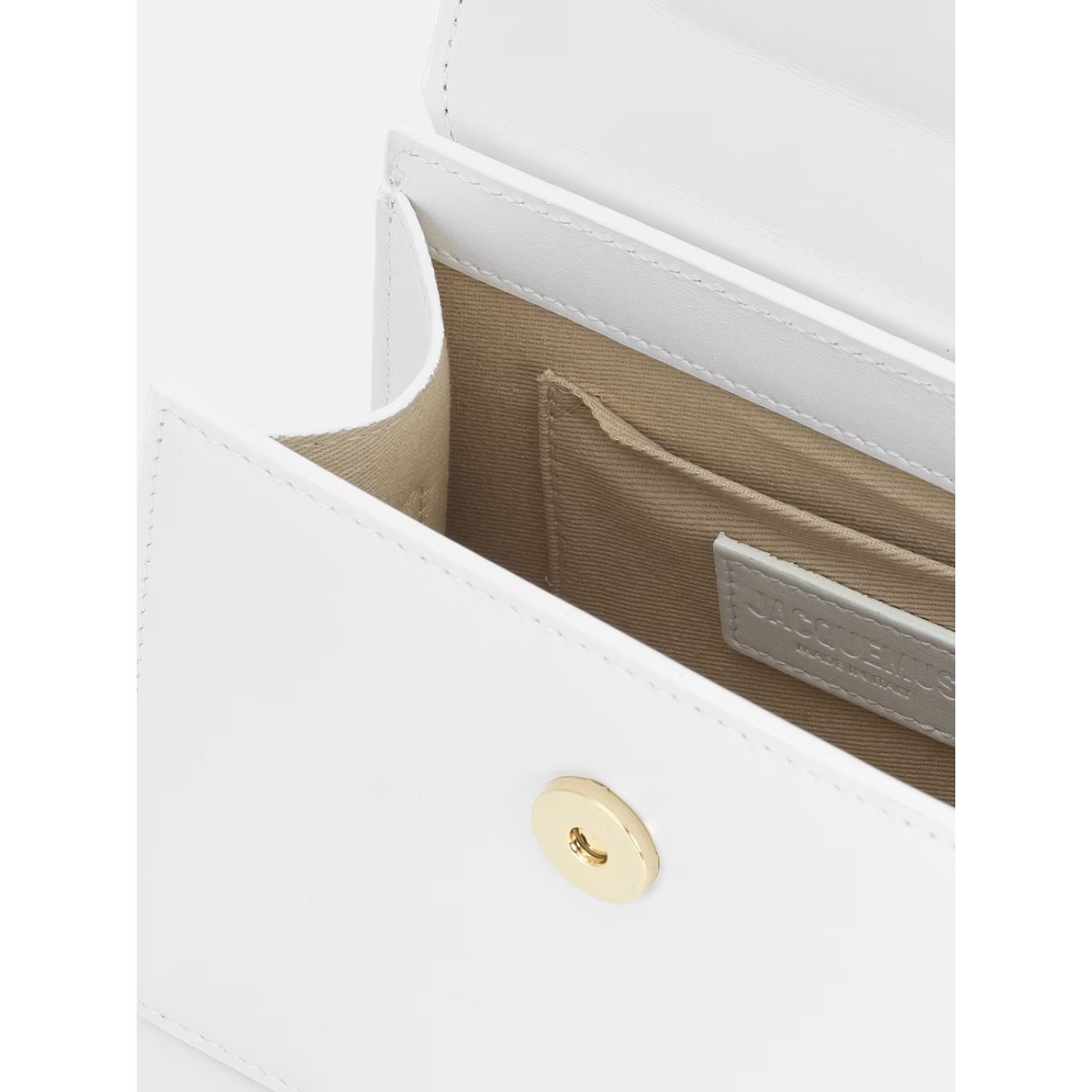 Interior view of Jacquemus White Le Chiquito Moyen Bag with gold hardware, showing pocket and lining detail.
