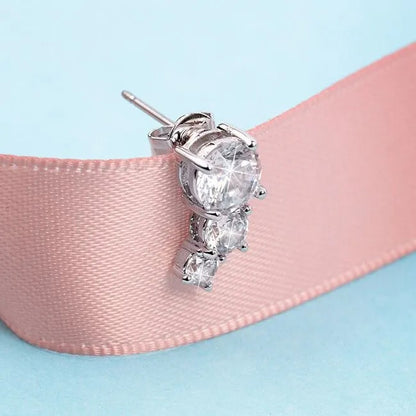 LA PETITE STORY JEWELRY Mod. LPS02ARQ129 silver earring with gemstones on a pink ribbon background