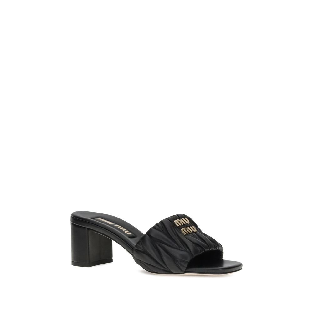 Miu Miu Black Lamb Ovis Aries Aries Stiletto Heel Sandals featuring a squared toe and padded straps with metal plaque.