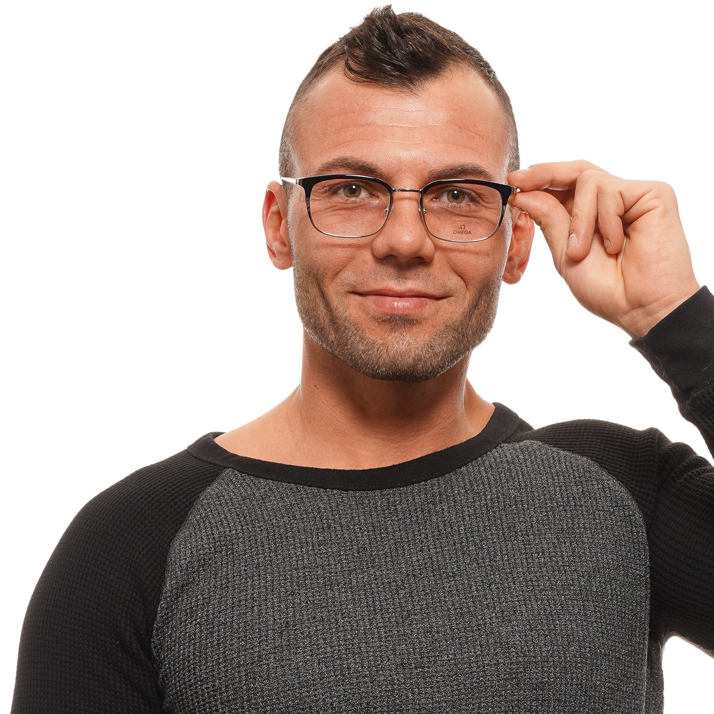 Man wearing glasses and a gray long-sleeve shirt smiling