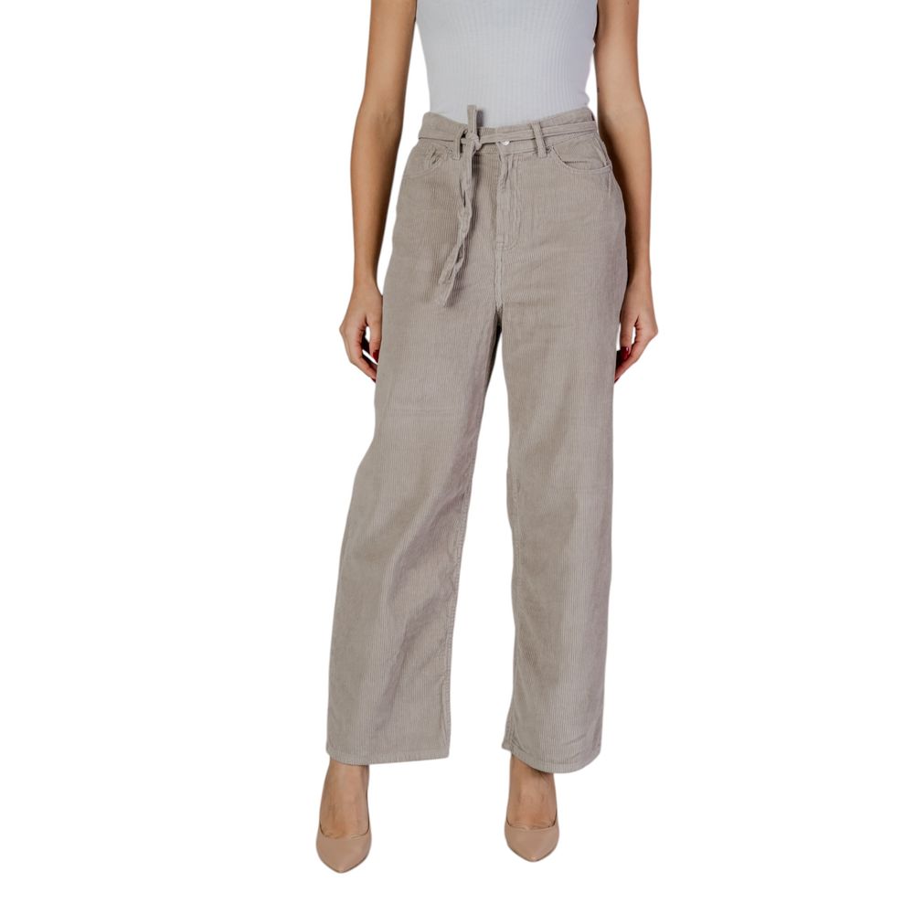 Woman wearing Only Beige Cotton Pant with belt, showcasing loose fit and casual style.