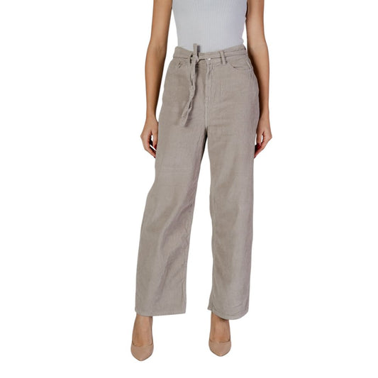 Woman wearing Only Beige Cotton Pant with belt, showcasing loose fit and casual style.