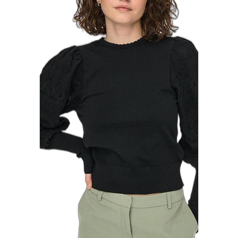Woman wearing Only Black Polyester Sportswear sweater with textured long sleeves and round neckline.