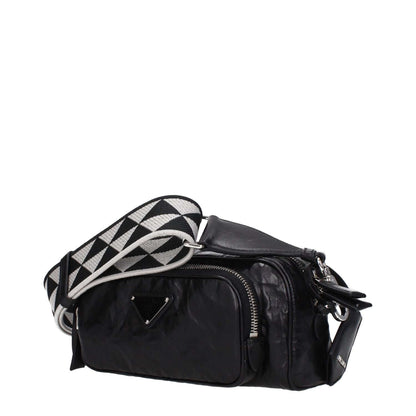 Prada Black Leather Crossbody Bag with adjustable strap, silver details, and zip closure. Compact design with 1 internal and 1 external pocket.