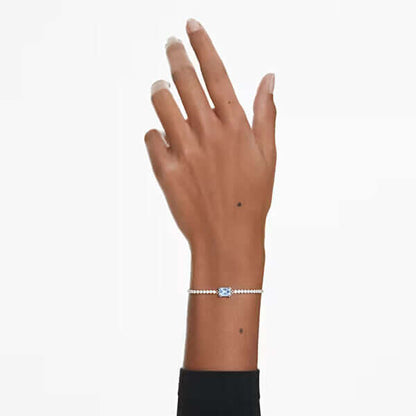 Elegant lady's hand wearing a delicate SWAROVSKI bracelet showcasing quartz analog design, perfect for formal occasions.