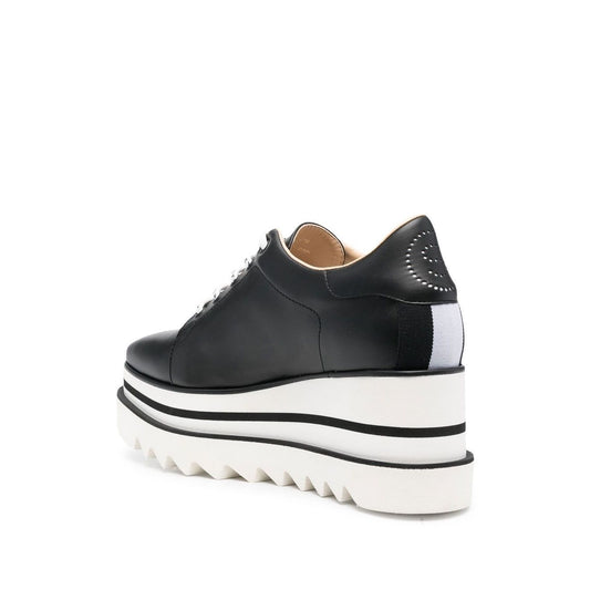 Stella McCartney Sneakers Black with high wedge heel and rubber sole, side view of Elyse Eco Alter low-top sneakers.