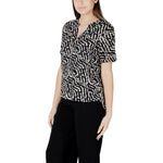 Street One Black Viscose Blouse with short sleeves and V-neck design, modeled on a woman wearing black trousers, showcasing casual elegance.
