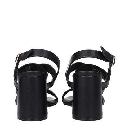 Back view of Stuart Weitzman Black Leather Platform Sandals with buckle closure and mid heels, showcasing the open toe design.