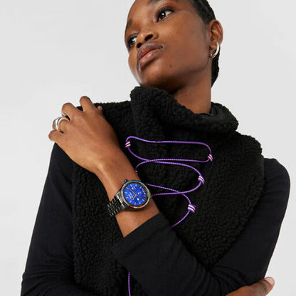 Model wearing TOUS WATCHES Mod. 200351040 with a blue dial and black strap, paired with a stylish black outfit and accessories.