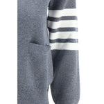 Close-up of Thom Browne Cardigan featuring striped black and white cuffs, fleece wool fabric, part of the iconic design.
