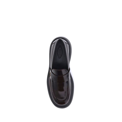 Top view of Tod's Brown Rubber Platform Loafers featuring patent leather, rounded toe, rubber sole, and side logo plaque.