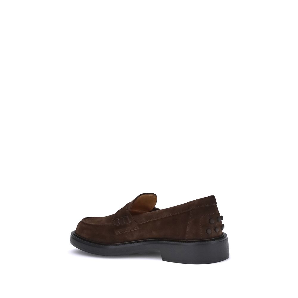 Side view of Tod's Brown Rubber Slip-On Loafers showcasing hand-stitched vamp and rubber sole with embossed pebbles for comfort.