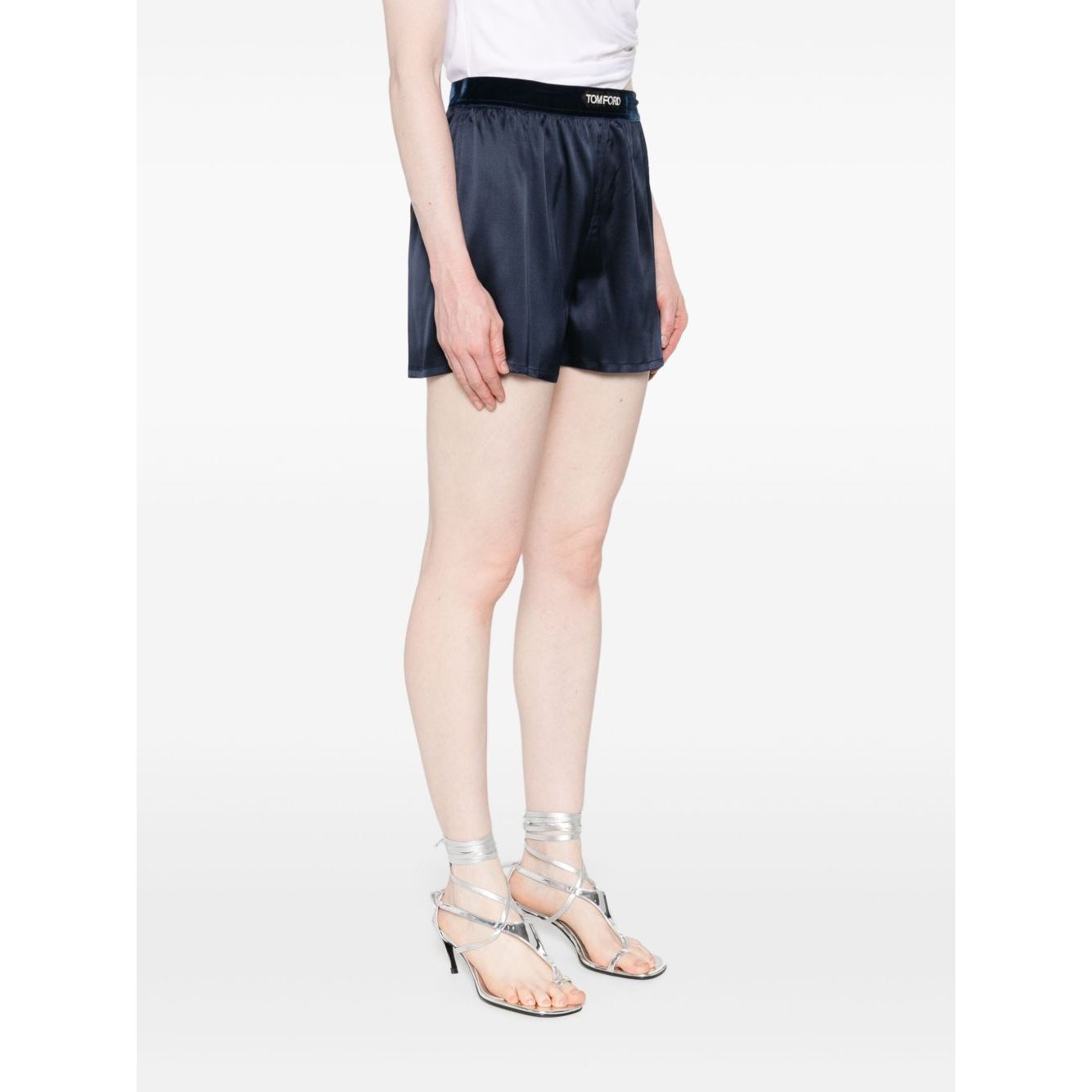 Model wearing Tom Ford Shorts Blue with elasticated waistband and logo, silk navy shorts, size S, true to size fit, stylish summer wear.