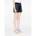 Model wearing Tom Ford Shorts Blue with elasticated waistband and logo, silk navy shorts, size S, true to size fit, stylish summer wear.