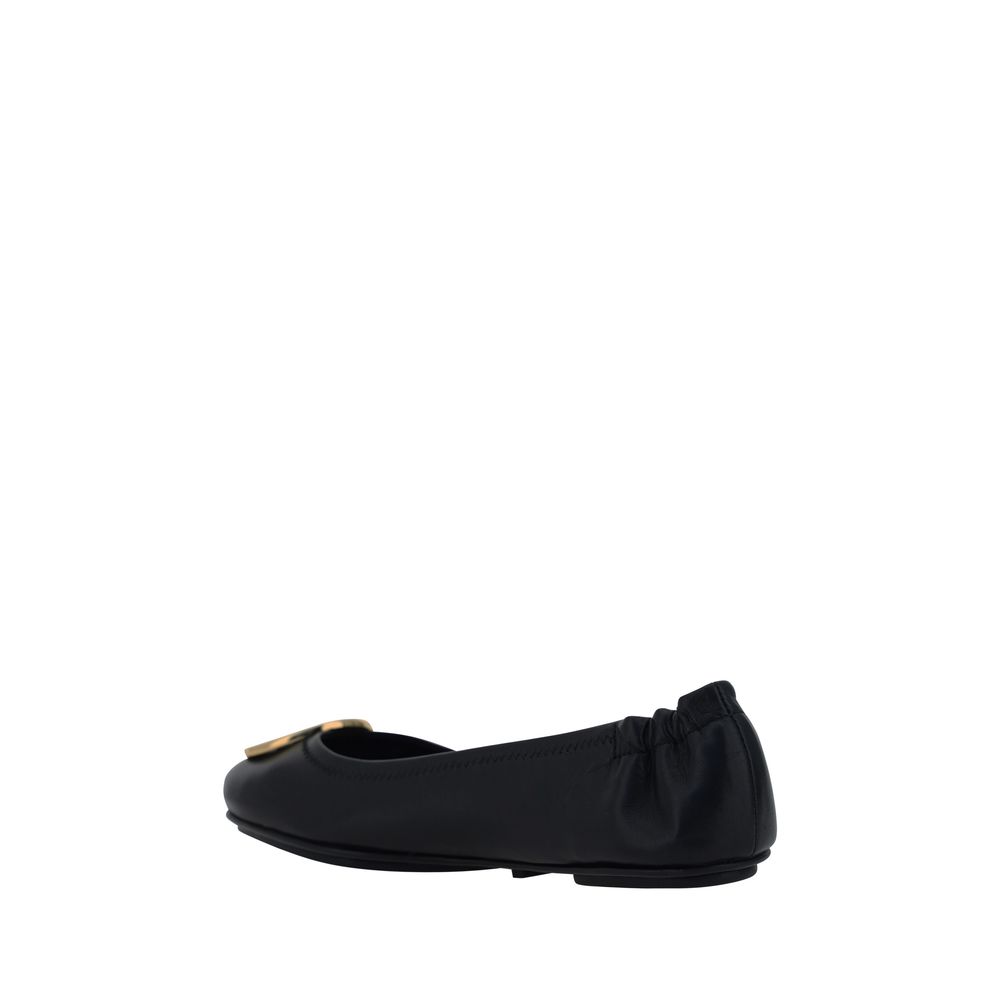 Side view of Tory Burch Black Lamb Ovis Aries Aries Ballet Flats, featuring a slip-on design and embossed monogram plaque.