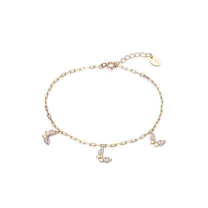 Gold bracelet with butterfly charms, delicate chain design, suitable for elegant wear. A dainty jewelry piece for women.