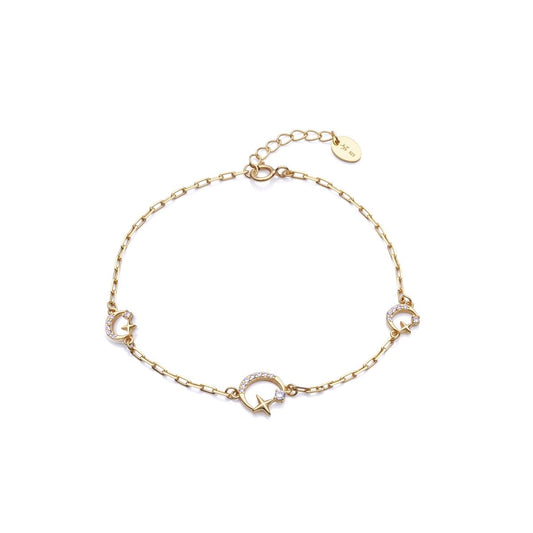 Gold bracelet with star and moon charms, featuring elegant design with a delicate chain and clasp for ladies.