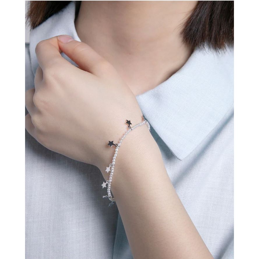 Woman wearing VICEROY JEWELS Mod. 13204P000-90 silver 925° bracelet with star design on wrist, featuring quartz analog movement.