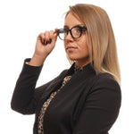 Woman wearing Valentino Black Women Glasses Frame, stylish round full-rim design, black plastic frame and demo lenses, professional look.