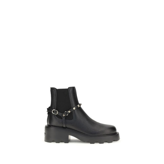 Valentino Garavani Black Calf Leather Bos Taurus Ankle Boots with studs and elastic inserts on a white background.