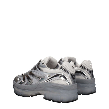 Valentino Garavani Gray Fabric Athletic Sneakers with studs, round toe, mid heels, and lace-up closure in silver fabric.