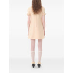 Back view of Valentino Short Crepe Couture Dress in beige with bow detailing, rear zip fastening, crew neck, wool and silk blend.