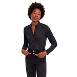 Woman wearing Vero Moda Black Cotton Bodysuit with long sleeves, showcasing a versatile and elegant design.