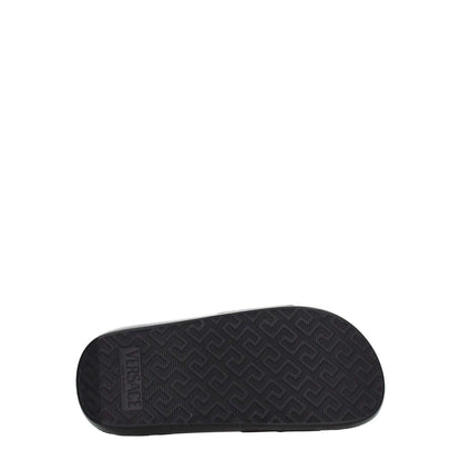 Versace Black Leather Slippers showing the rubber sole with logo and textured pattern, designed for casual wear with an open toe and low heel.