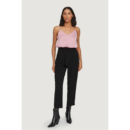Model wearing Vila Clothes Black Viscose Cropped Pants with pink top, black ankle boots, showcasing high-waisted design and straight leg style.