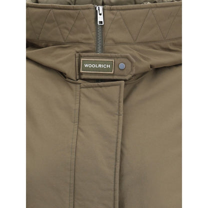 Woolrich Green Cotton Parka close-up showing quilted high collar, double-slider zipper, and Woolrich label detailing.